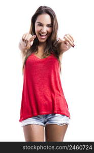 Beautiful young woman looking and pointing to the camera, isolated over a white background