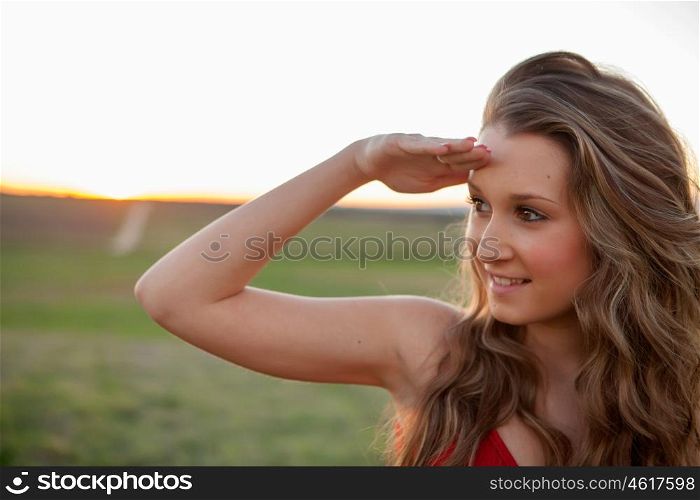 Beautiful young woman looking at side in the countryside with beautiful light