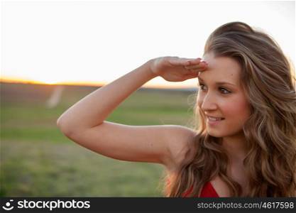 Beautiful young woman looking at side in the countryside with beautiful light
