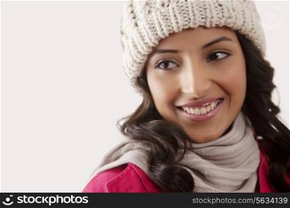 Beautiful young woman looking away on white background