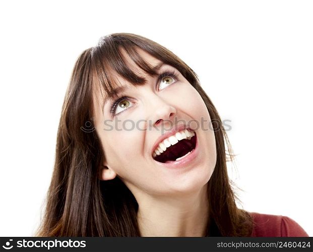 Beautiful young woman looking up and laughing, isolated on a white background