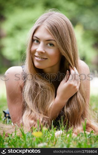 Beautiful young woman lying on grass. Beautiful young woman lying on grass in park