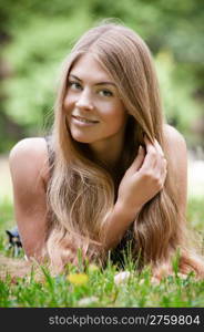 Beautiful young woman lying on grass. Beautiful young woman lying on grass in park