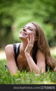 Beautiful young woman lying on grass. Beautiful young woman lying on grass in park