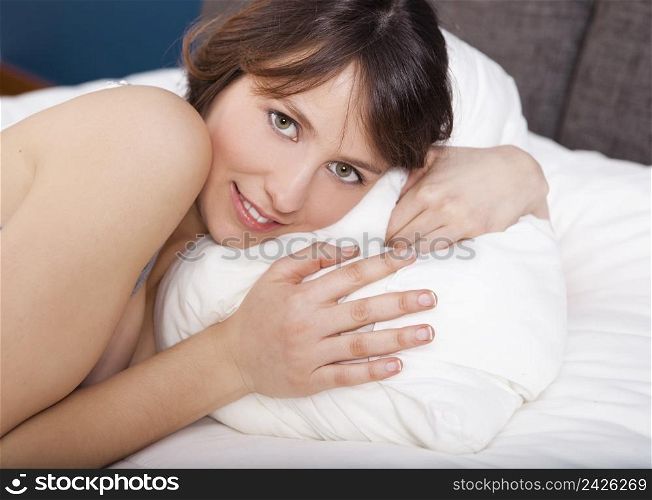 Beautiful young woman lying on the bed