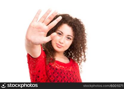 Beautiful young woman making stop sign with her right hand