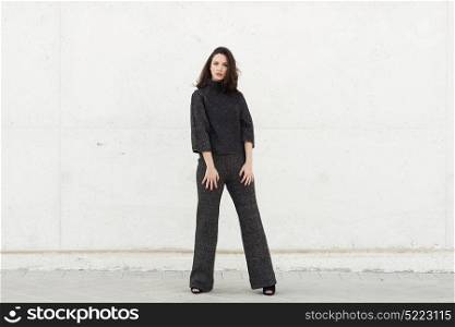 Beautiful young woman, model of fashion, in urban background