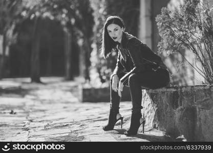 Beautiful young woman, model of fashion, in urban background