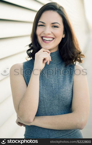 Beautiful young woman, model of fashion, smiling in urban background