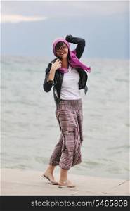 beautiful young woman on beach with scarf relax smile and have fun