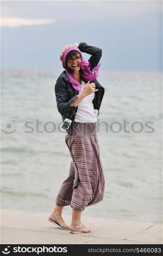 beautiful young woman on beach with scarf relax smile and have fun