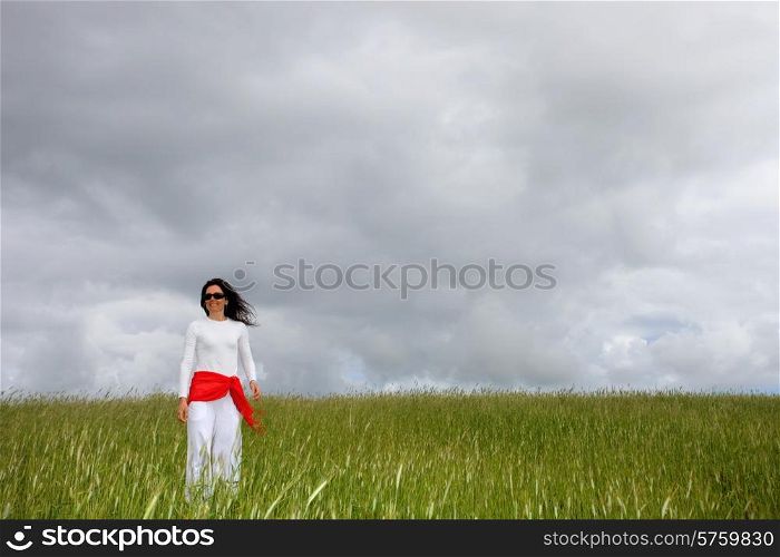 beautiful young woman on field with a red scarf
