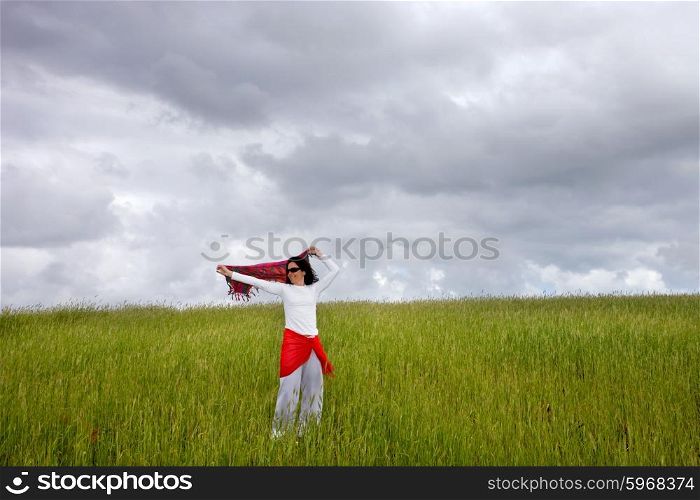 beautiful young woman on field with a red scarf