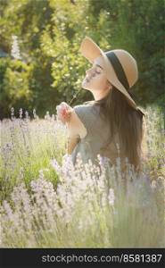 Beautiful young woman on lavender field. Sunset. Attractive young fema≤outdoors.