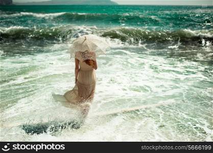 Beautiful young woman on the beach. Ocean. Fashion photo