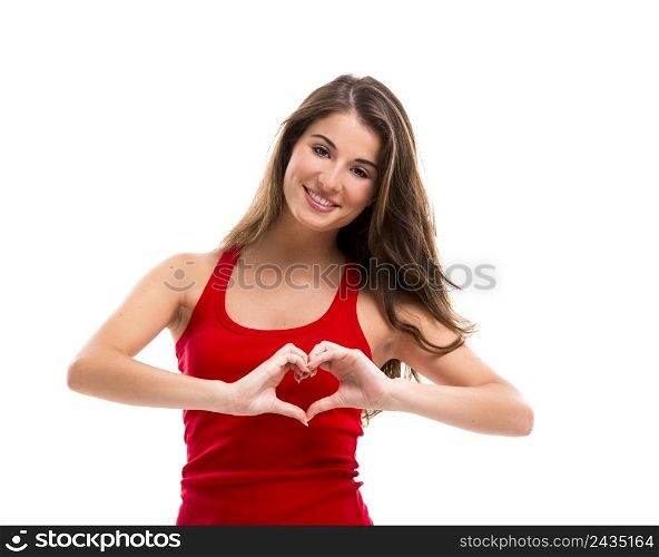 Beautiful young woman over a white background doing a heart shape with her hands