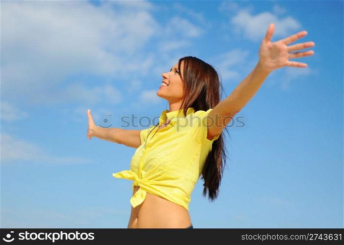 Beautiful young woman over blue sunny sky