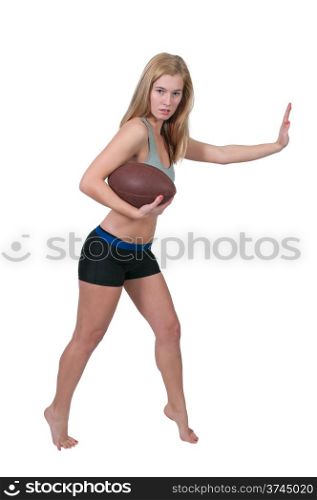 beautiful young woman playing a game of football running with the ball