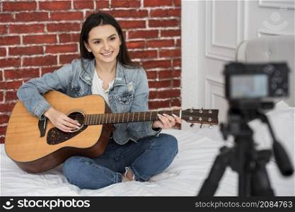 beautiful young woman playing guitar