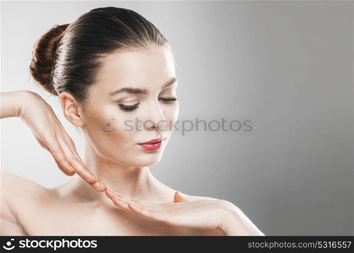 Beautiful young woman portrait. Beautiful young woman with clean fresh skin portrait on gray background