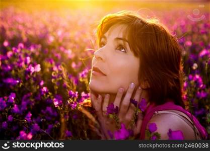 Beautiful young woman portrait on a flowery meadow