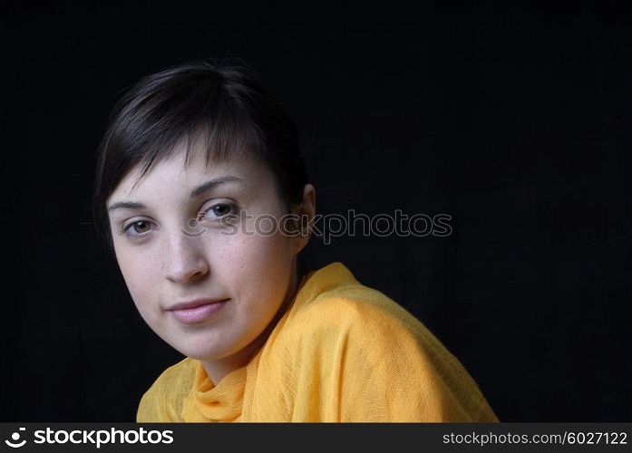 beautiful young woman posing in black background