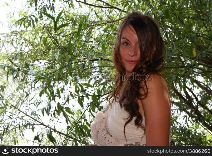 Beautiful young woman posing in wedding dress