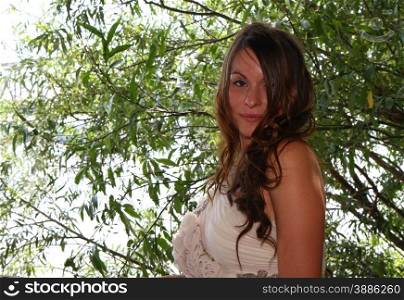 Beautiful young woman posing in wedding dress