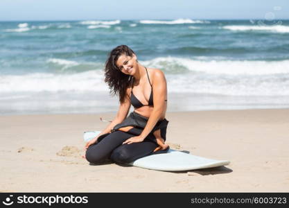 Beautiful young woman preparing to another day of surf