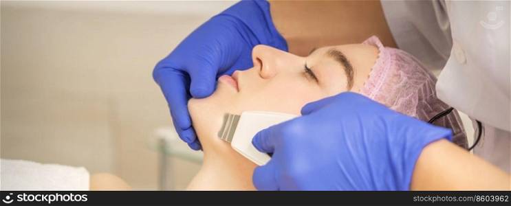 Beautiful young woman receiving ultrasonic cavitation facial cleansing in beauty spa salon. Woman receiving ultrasonic facial cleansing