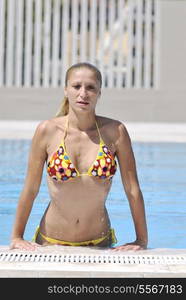 beautiful young woman relax and have fun at swimming pool