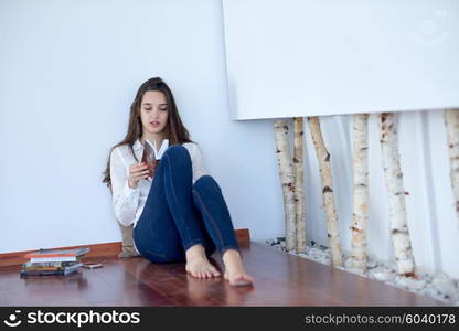 beautiful young woman relax and work on laptop computer modern home office while listening musin on white headphones