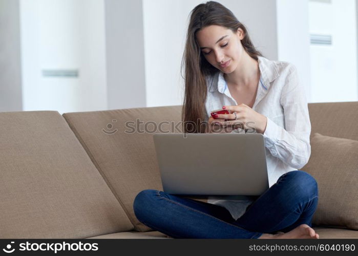 beautiful young woman relax and work on laptop computer modern home office while listening musin on white headphones