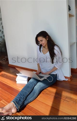 beautiful young woman relax and work on laptop computer modern home office