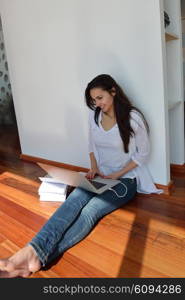 beautiful young woman relax and work on laptop computer modern home office