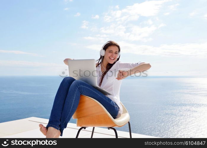 beautiful young woman relax and work on laptop computer while working on laptop computer and read book at home