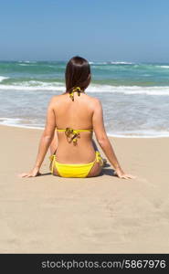 Beautiful young woman relaxing at the beach