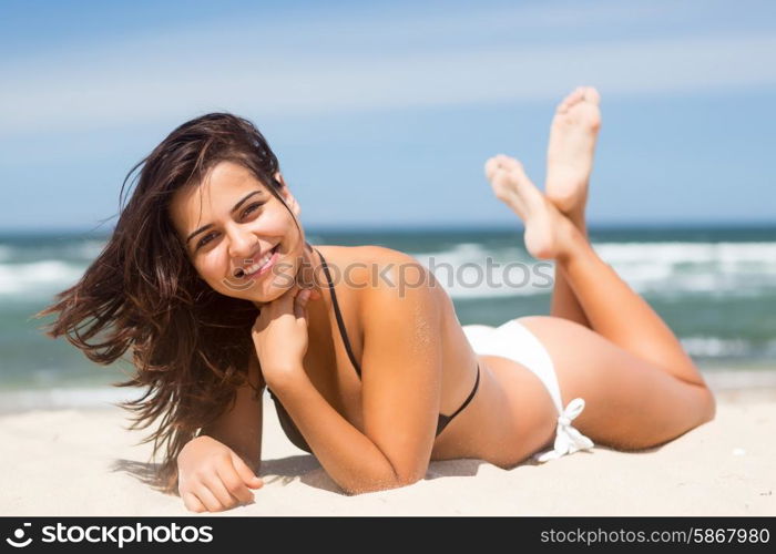 Beautiful young woman relaxing at the beach