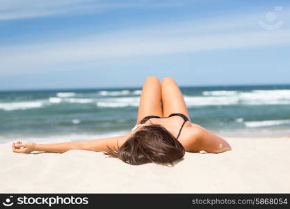 Beautiful young woman relaxing at the beach