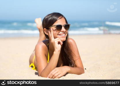 Beautiful young woman relaxing at the beach