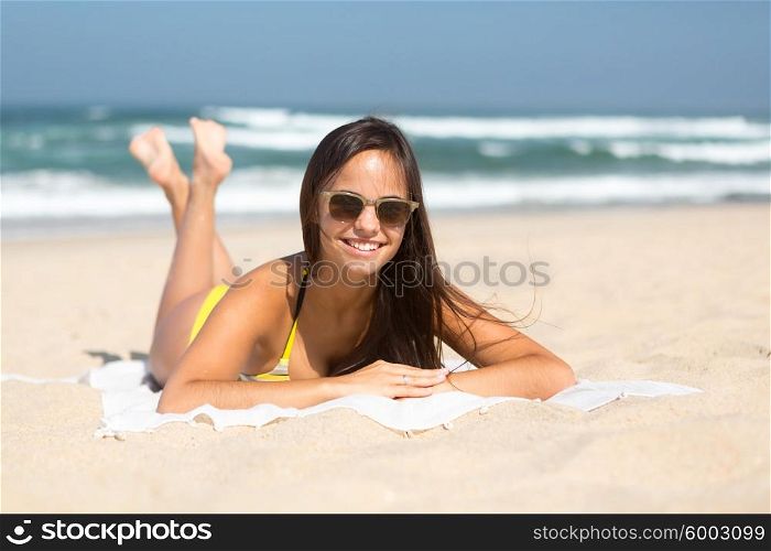 Beautiful young woman relaxing at the beach