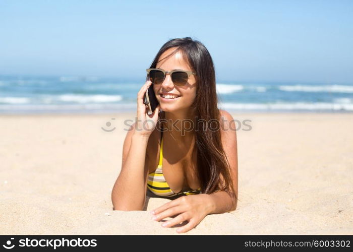 Beautiful young woman relaxing at the beach