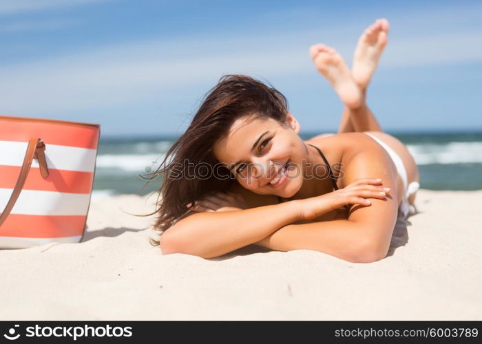 Beautiful young woman relaxing at the beach