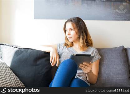 Beautiful young woman relaxing at the living room