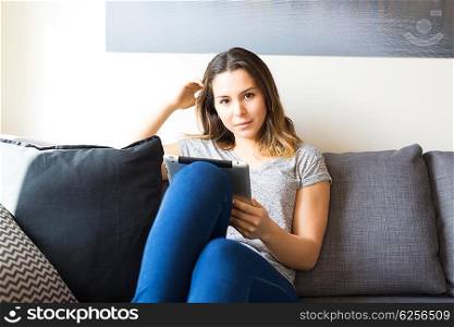 Beautiful young woman relaxing at the living room