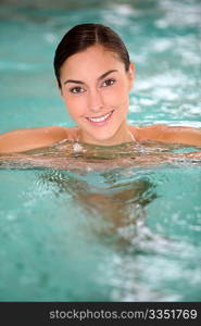 Beautiful young woman relaxing in seawater pool