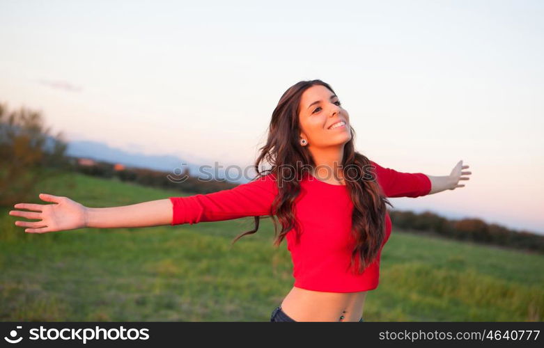 Beautiful young woman relaxing in the countryside with beautiful light