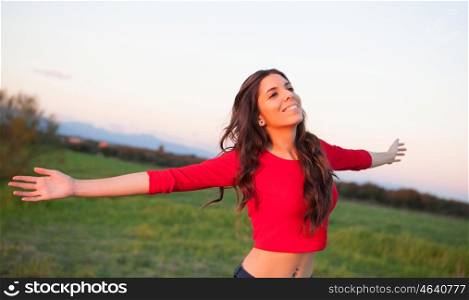 Beautiful young woman relaxing in the countryside with beautiful light