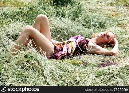 beautiful young woman relaxing in the grass