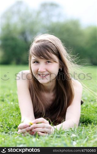 beautiful young woman relaxing in the grass